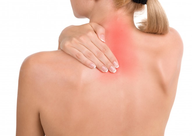 Woman holds a hand on pain neck. Backache